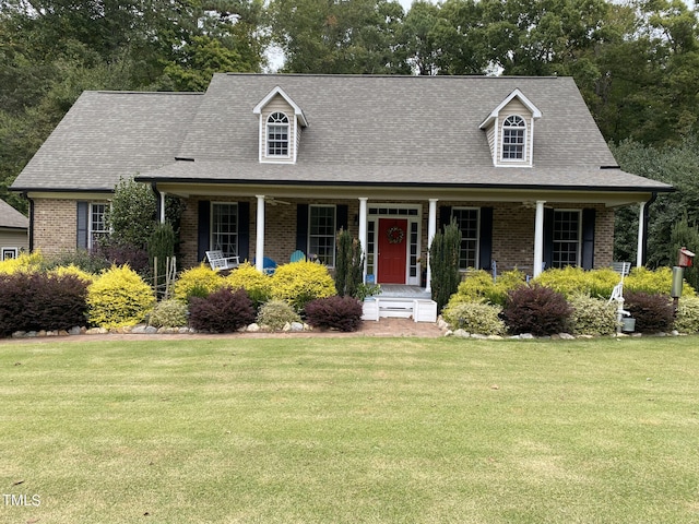 cape cod-style house with a front yard and a porch