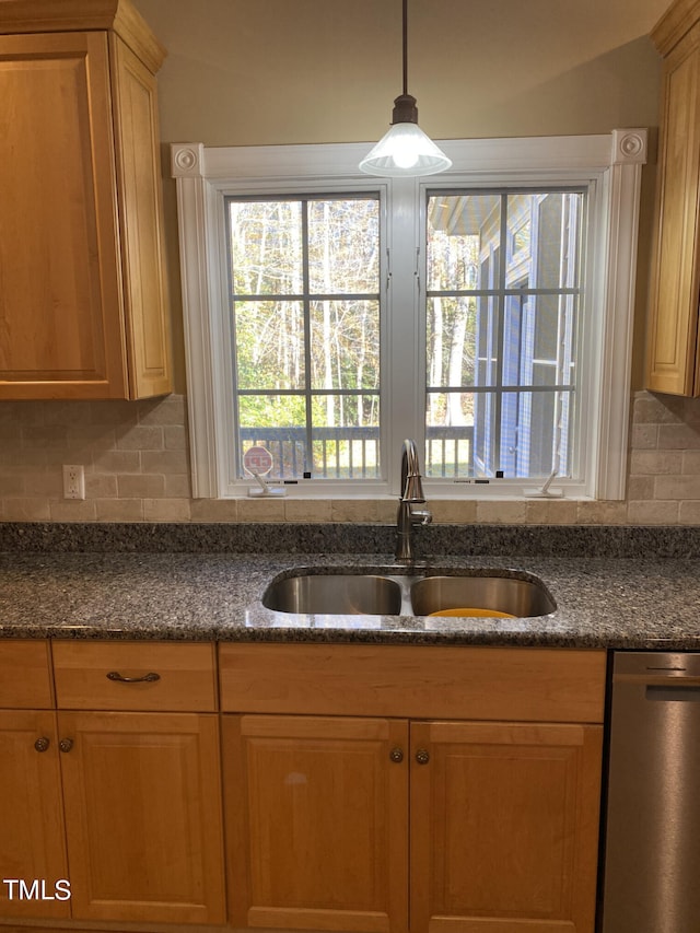 kitchen with sink, backsplash, dishwasher, and decorative light fixtures