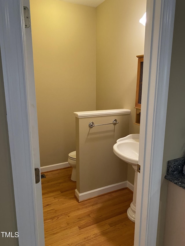 bathroom featuring toilet and hardwood / wood-style floors