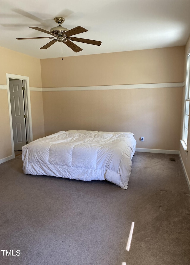 bedroom featuring dark colored carpet and ceiling fan