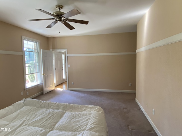 unfurnished bedroom featuring ceiling fan and carpet