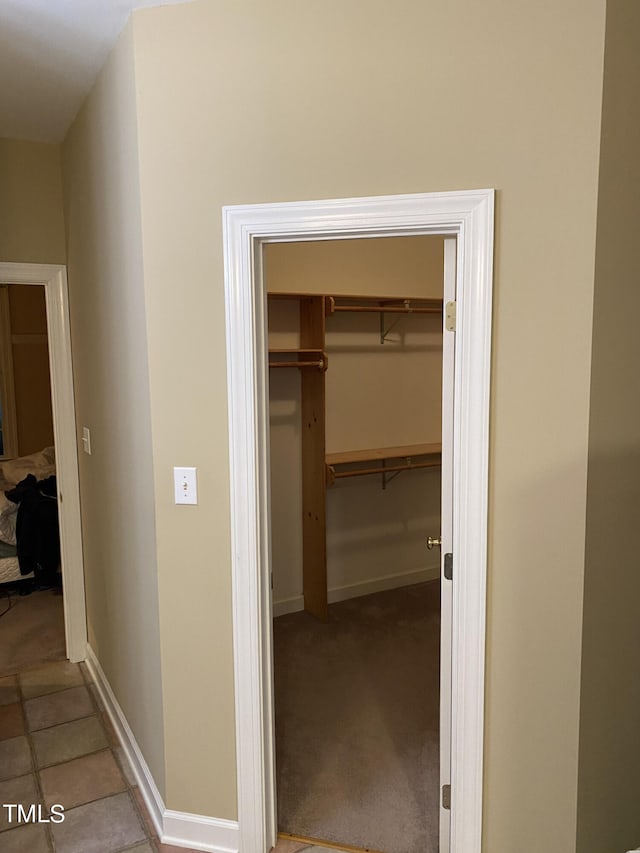 hall featuring light tile patterned flooring