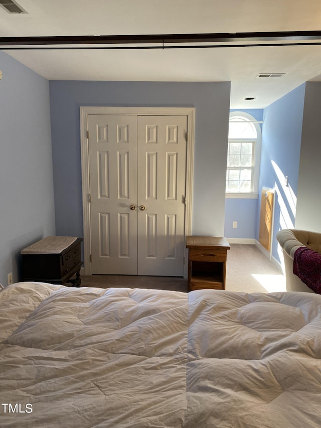 carpeted bedroom featuring a closet