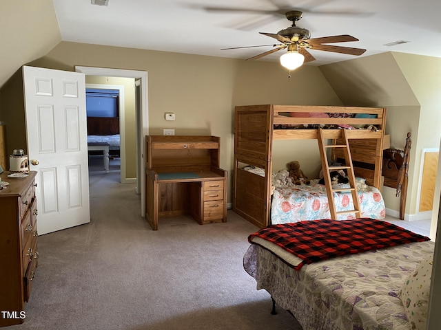 carpeted bedroom with vaulted ceiling and ceiling fan