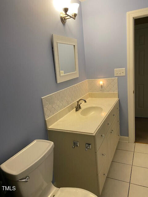 bathroom with vanity, toilet, and tile patterned flooring