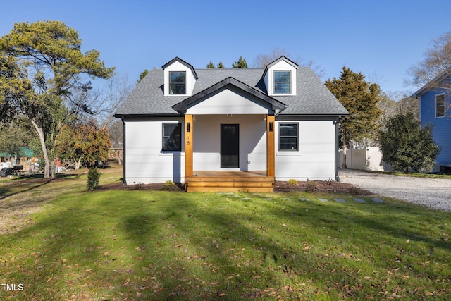 cape cod home with a front yard