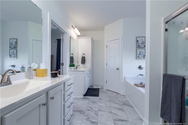 bathroom featuring vanity and independent shower and bath