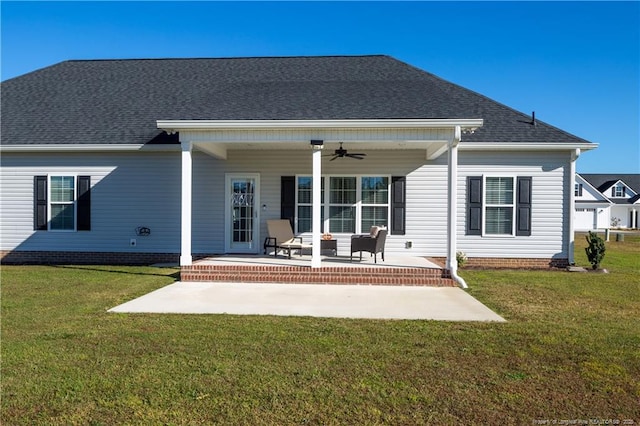 back of property featuring a lawn, a patio area, and ceiling fan