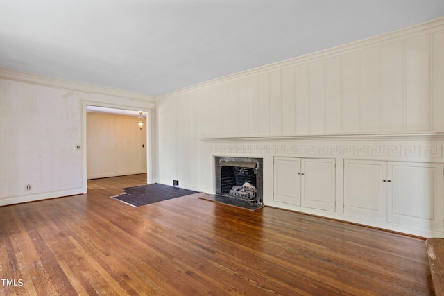 unfurnished living room featuring crown molding and wood-type flooring