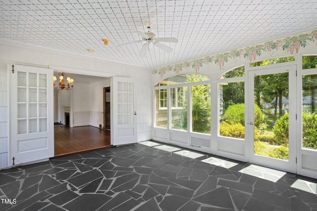 unfurnished sunroom featuring french doors and ceiling fan with notable chandelier