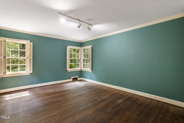 empty room featuring a healthy amount of sunlight and hardwood / wood-style flooring