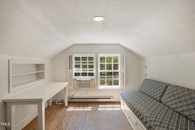 bonus room featuring vaulted ceiling, built in features, wood-type flooring, and a baseboard heating unit