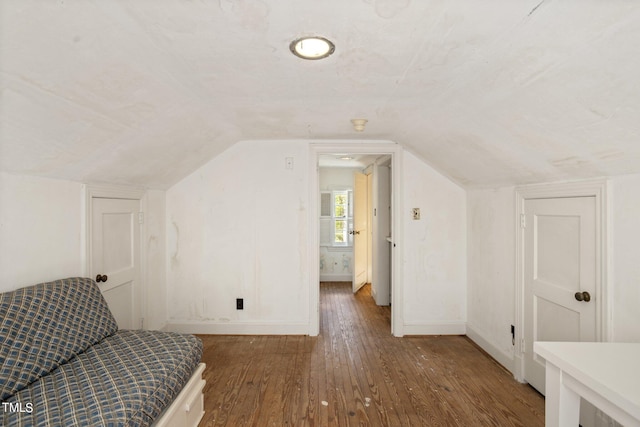 bonus room featuring lofted ceiling and dark hardwood / wood-style floors