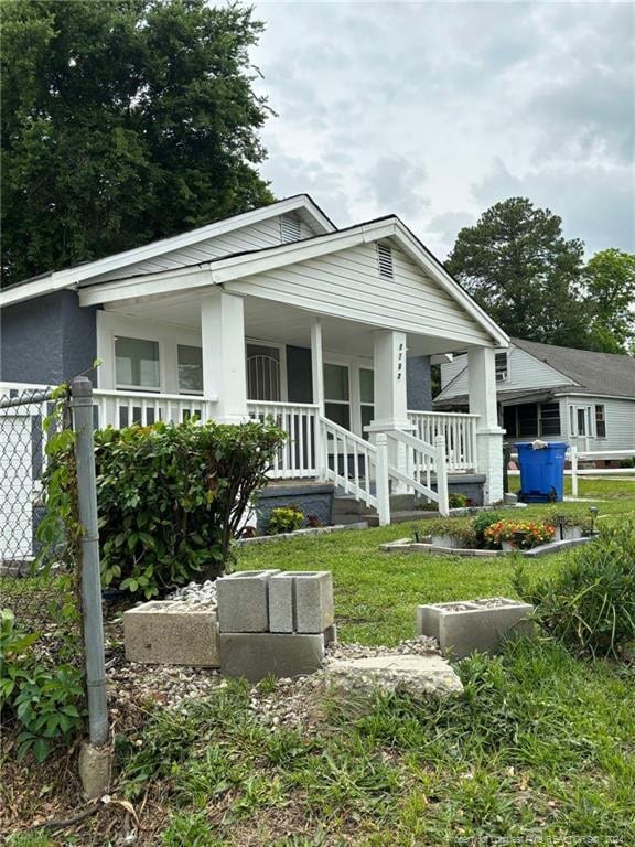 rear view of house with covered porch