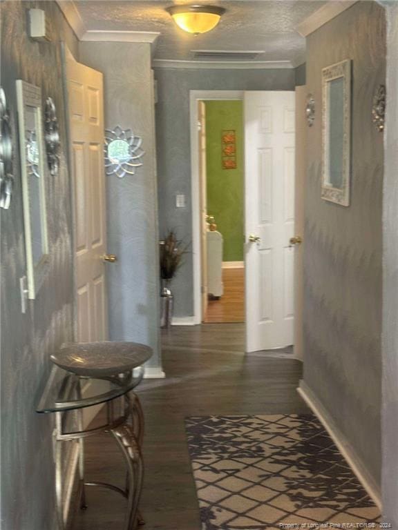 hallway featuring ornamental molding and dark hardwood / wood-style floors