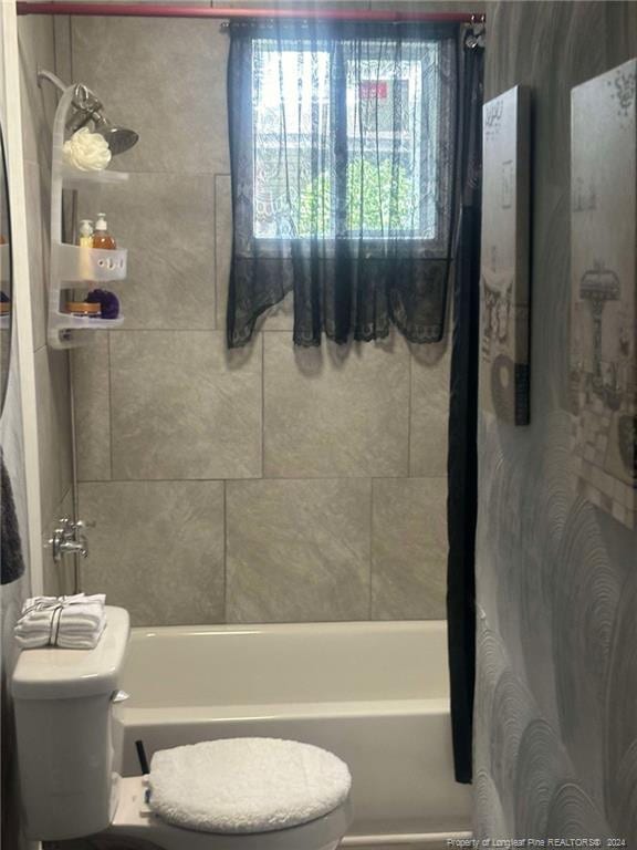 bathroom with shower / tub combo and toilet