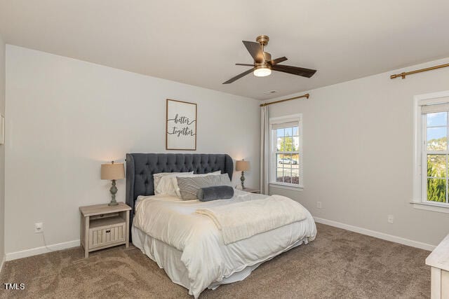 bedroom featuring ceiling fan, carpet flooring, and multiple windows