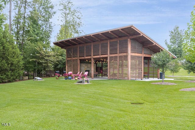 back of house with a patio and a lawn