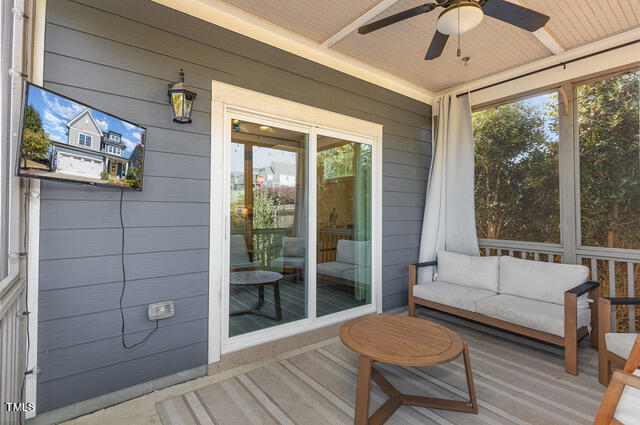 sunroom featuring wood ceiling, a healthy amount of sunlight, and ceiling fan