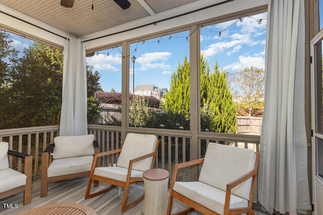 sunroom / solarium featuring ceiling fan and wooden ceiling