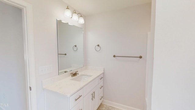 bathroom with baseboards and vanity