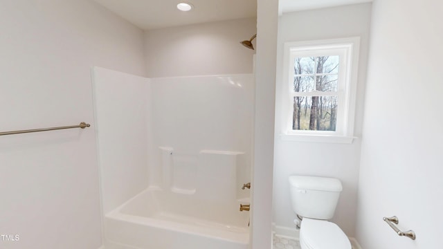 bathroom featuring toilet, baseboards, recessed lighting, and  shower combination