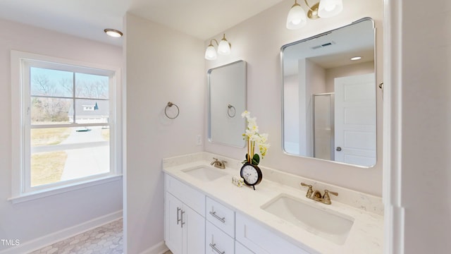 full bath with baseboards, double vanity, a sink, and visible vents
