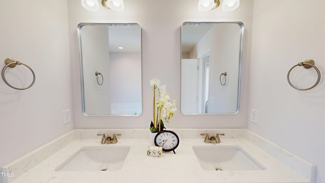 full bath with a sink and double vanity