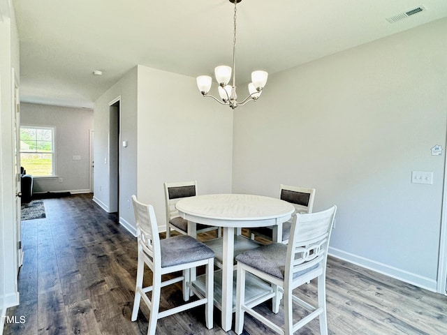 dining room with visible vents, baseboards, an inviting chandelier, and wood finished floors
