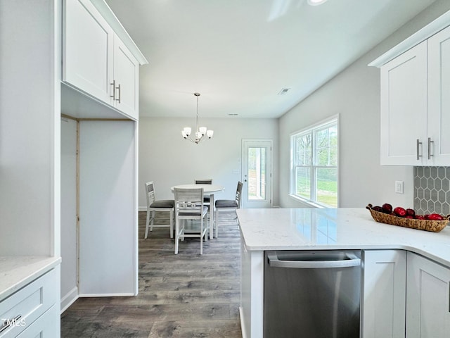 kitchen with light stone counters, a chandelier, white cabinets, dark wood finished floors, and stainless steel dishwasher