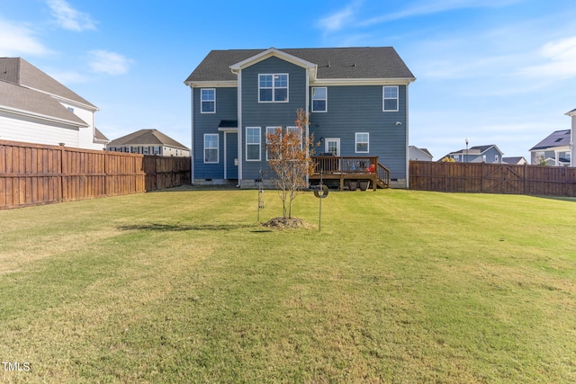 back of property with a wooden deck and a yard