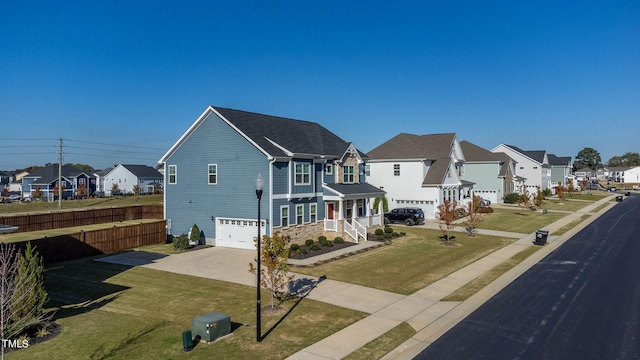 view of front of property with a front yard and a garage