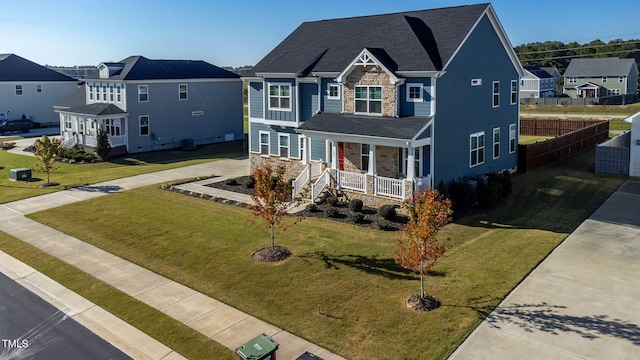 view of front of home with covered porch and a front yard