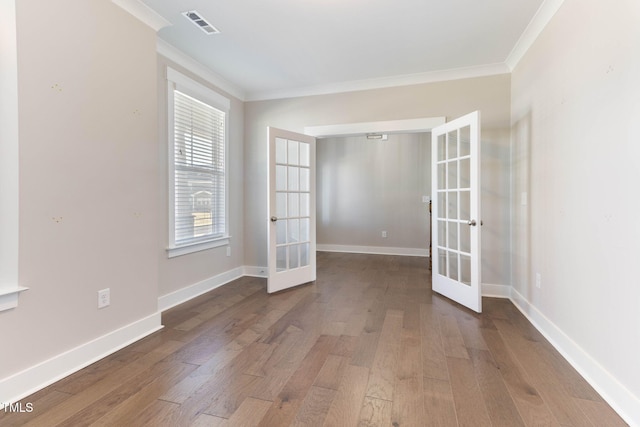 unfurnished room featuring wood-type flooring, ornamental molding, and french doors