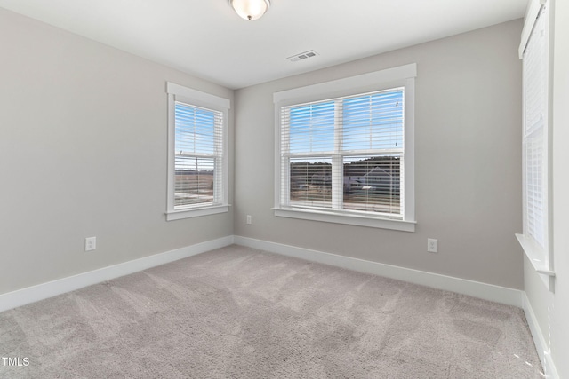 empty room featuring light carpet