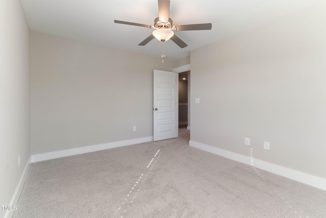 empty room with ceiling fan and carpet flooring