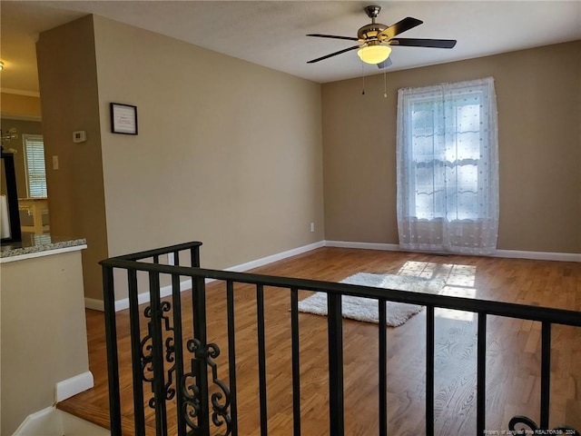 unfurnished room featuring ceiling fan and wood-type flooring