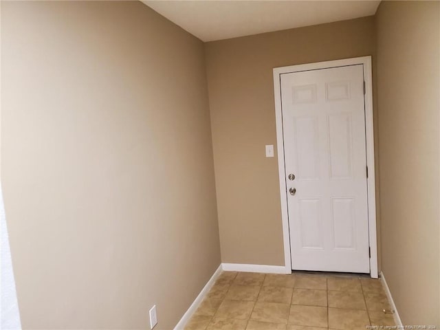 doorway to outside with light tile patterned floors