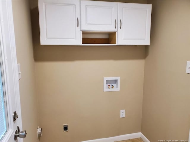 clothes washing area featuring hookup for an electric dryer, cabinets, and hookup for a washing machine