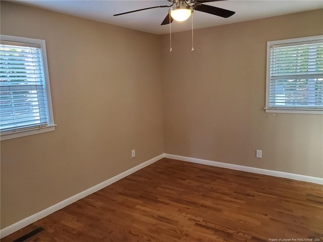 spare room with ceiling fan and wood-type flooring