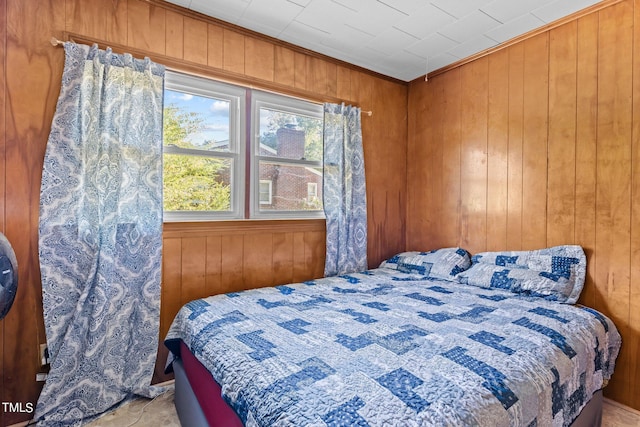 bedroom featuring wooden walls