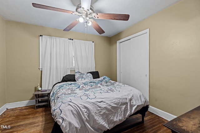 bedroom with a closet, dark hardwood / wood-style floors, and ceiling fan