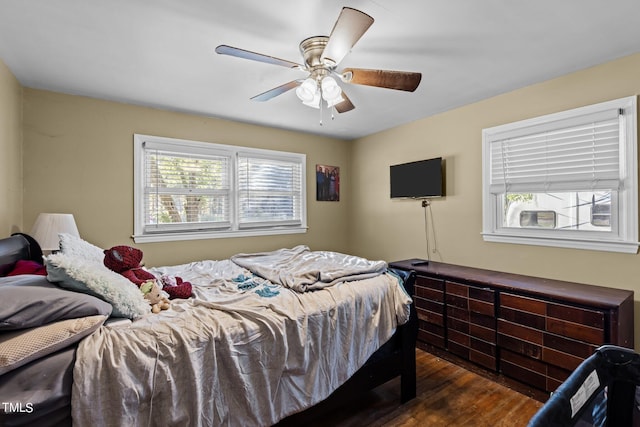 bedroom with ceiling fan and dark hardwood / wood-style floors