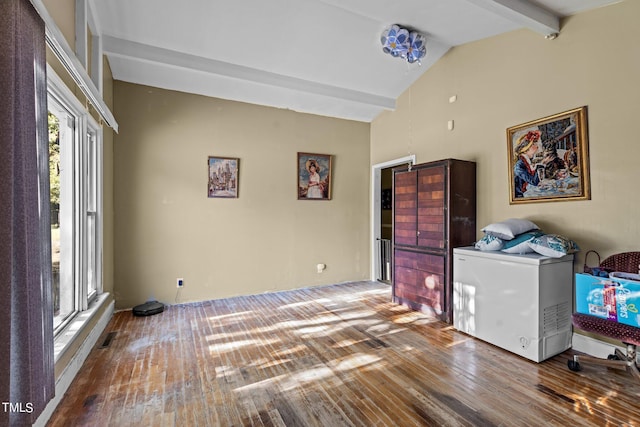 washroom featuring hardwood / wood-style flooring and a towering ceiling