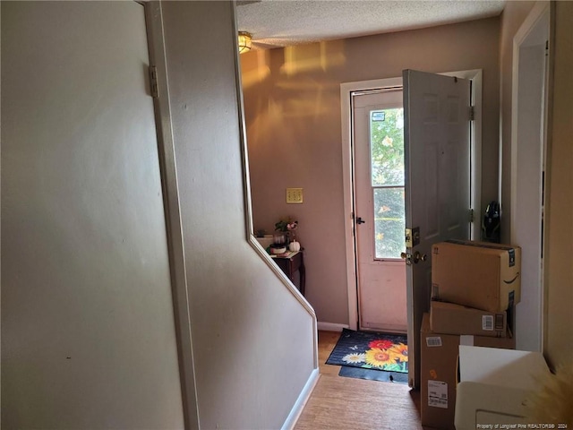 entryway featuring hardwood / wood-style flooring and a textured ceiling