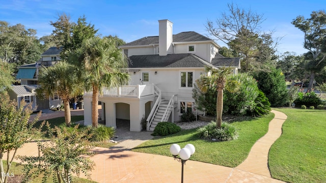 rear view of property featuring a lawn