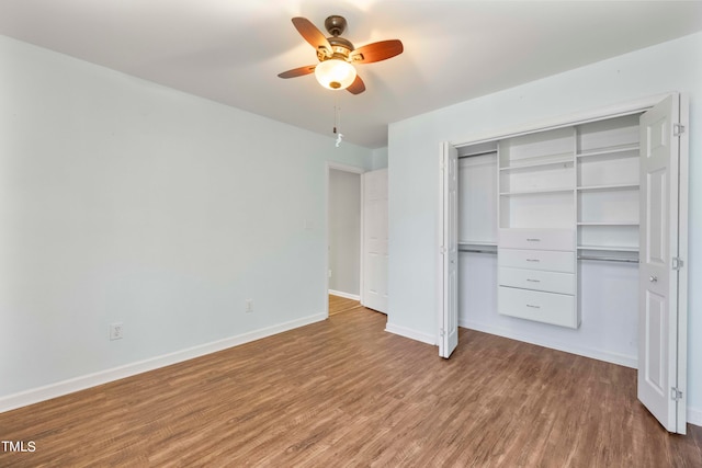 unfurnished bedroom featuring wood-type flooring, a closet, and ceiling fan