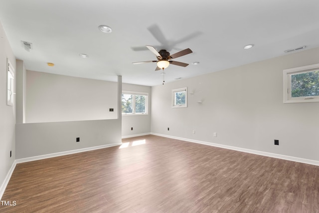 spare room with dark wood-type flooring and ceiling fan