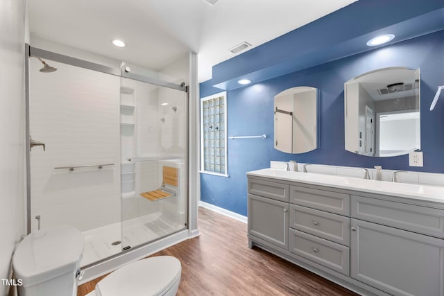 bathroom with vanity, toilet, an enclosed shower, and hardwood / wood-style floors