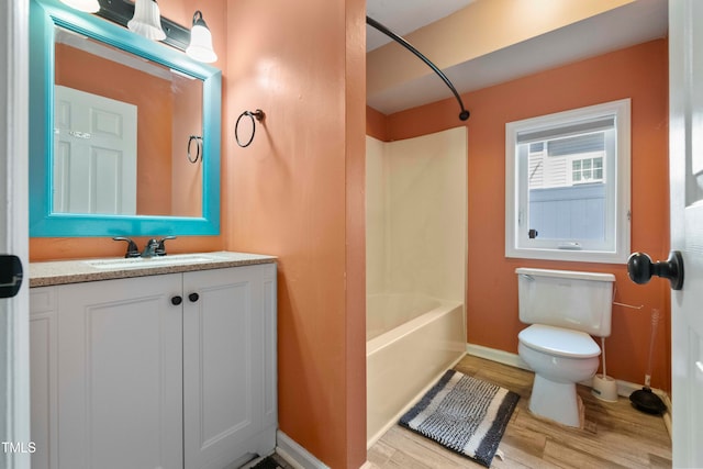 full bathroom featuring toilet, bathtub / shower combination, hardwood / wood-style floors, and vanity